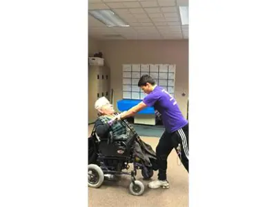 Trainer helping the member to exercise at the office