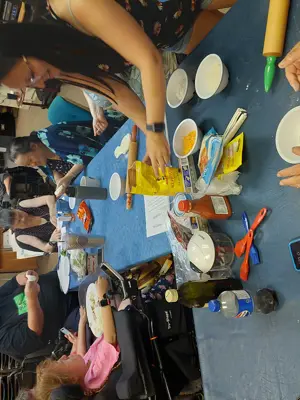 KWA members cooking for in the kitchen at the kwa office