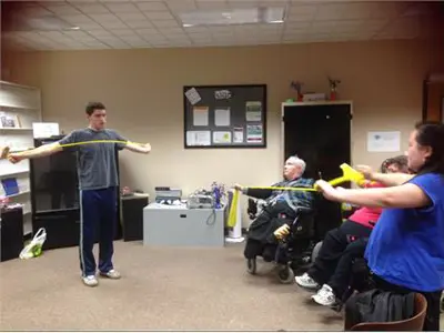 KWA members Exercising with Resistant bands at the office